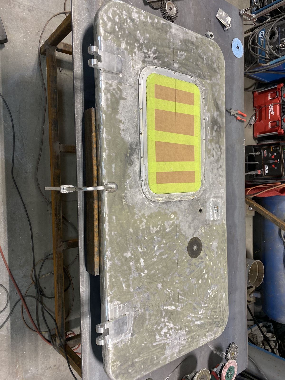 Aluminum hatch with TIG-welded hinges along one edge, seen from above
