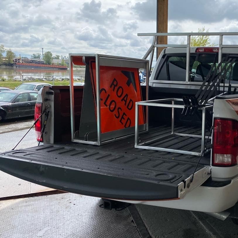 Fabricated aluminum sign racks in the bed of a pickup truck