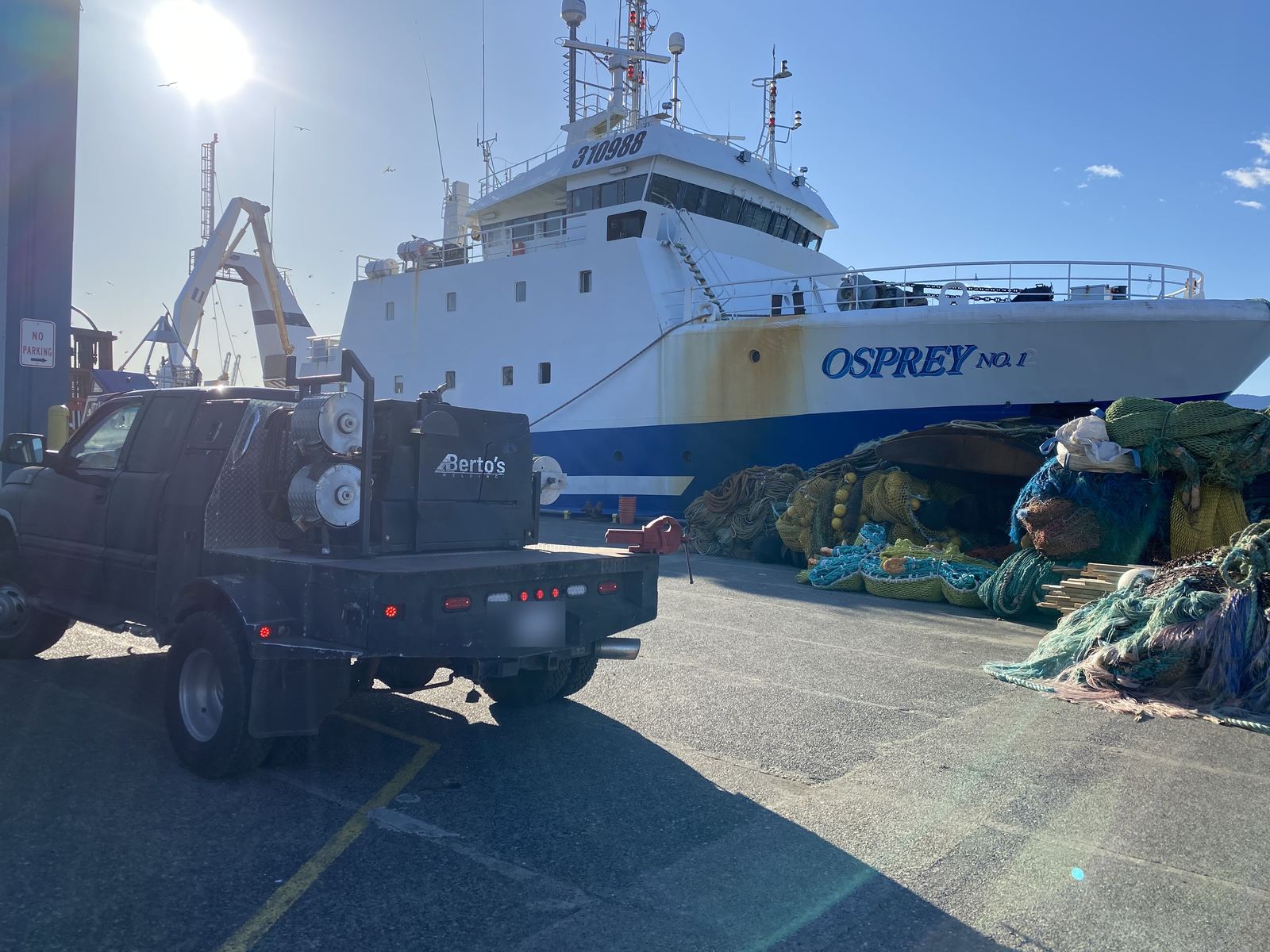 Berto's Welding truck at a commercial dock beside the vessel Osprey No. 1