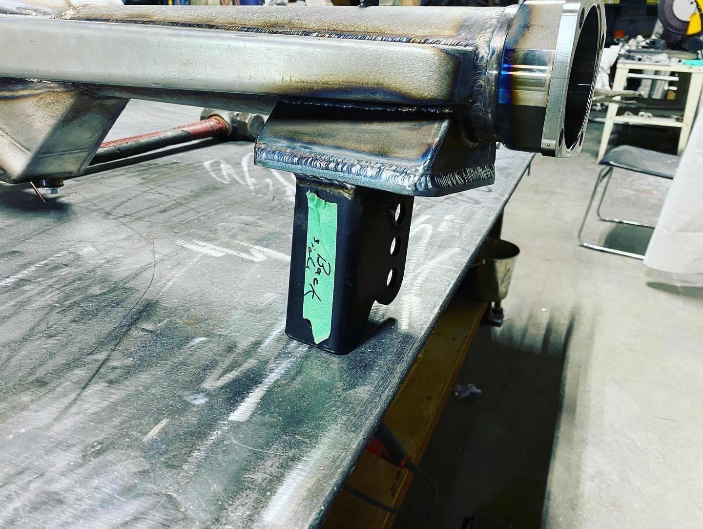 Fabricated stainless steel tube assembly with a welded bracket, clamped on a welding table