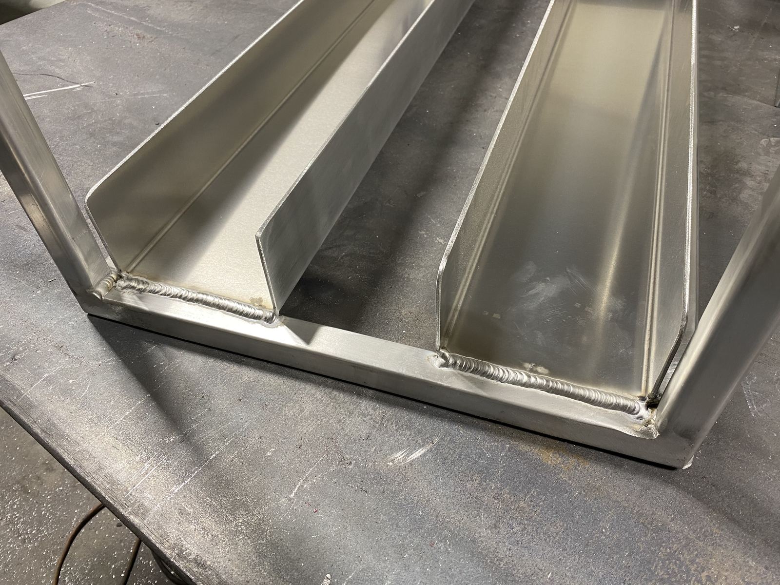 Fabricated aluminum channel with TIG-welded corner and seam joints