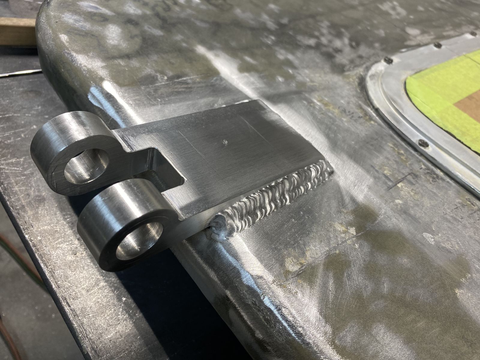 TIG-welded aluminum hinge on an aluminum hatch, with the bead running along the plate edge